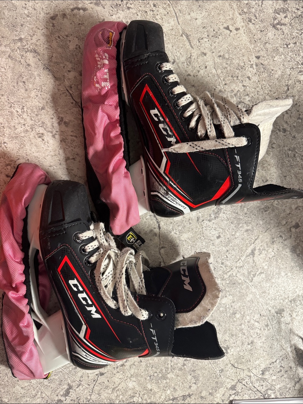 Size 4 CCM Kids Black and Red Ice Hockey Skates with Pink Blade Covers